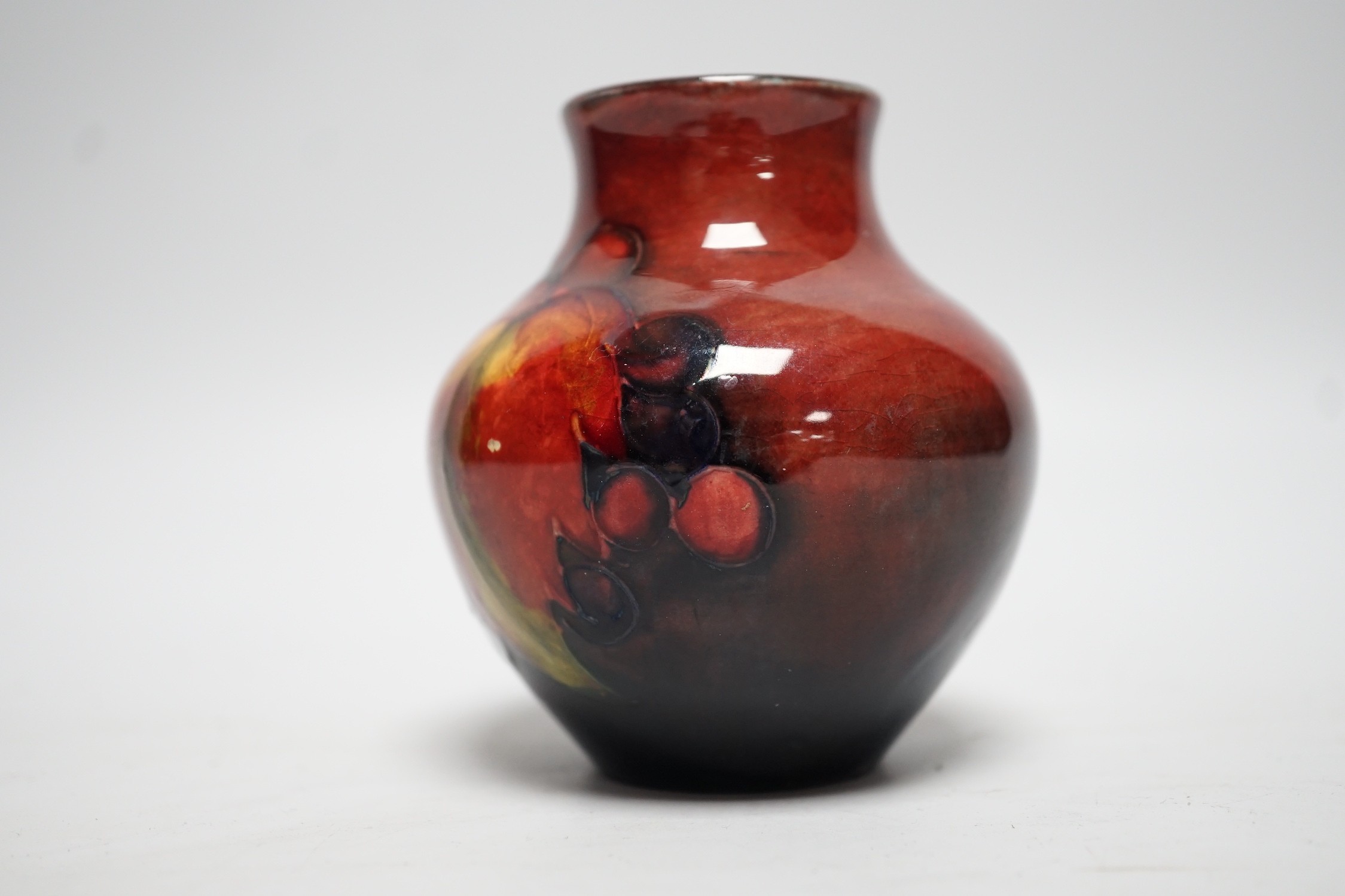 A Moorcroft flambé leaf and berry vase, 8cm
